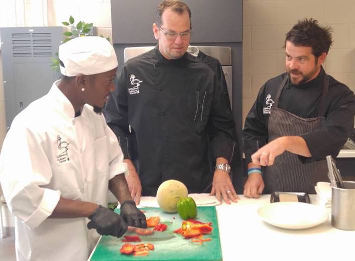 Chef Tyson and Chef Jeffrey teaching chopping techniques