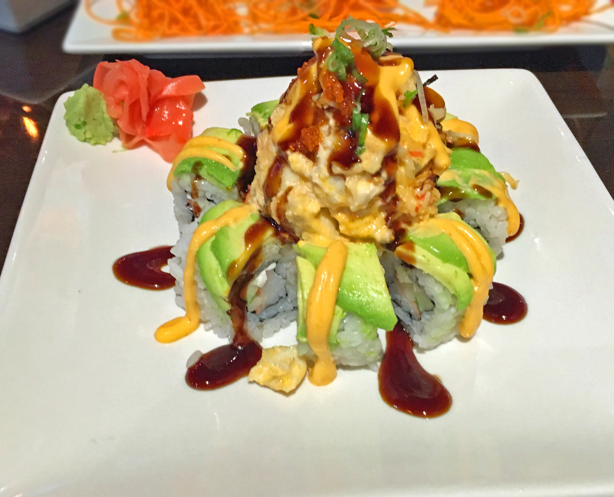 VESUVIUS AKA VOLCANO - Krab stick, cucumber and cream cheese roll topped with avocado, baked dynamite, eel sauce and spicy mayo