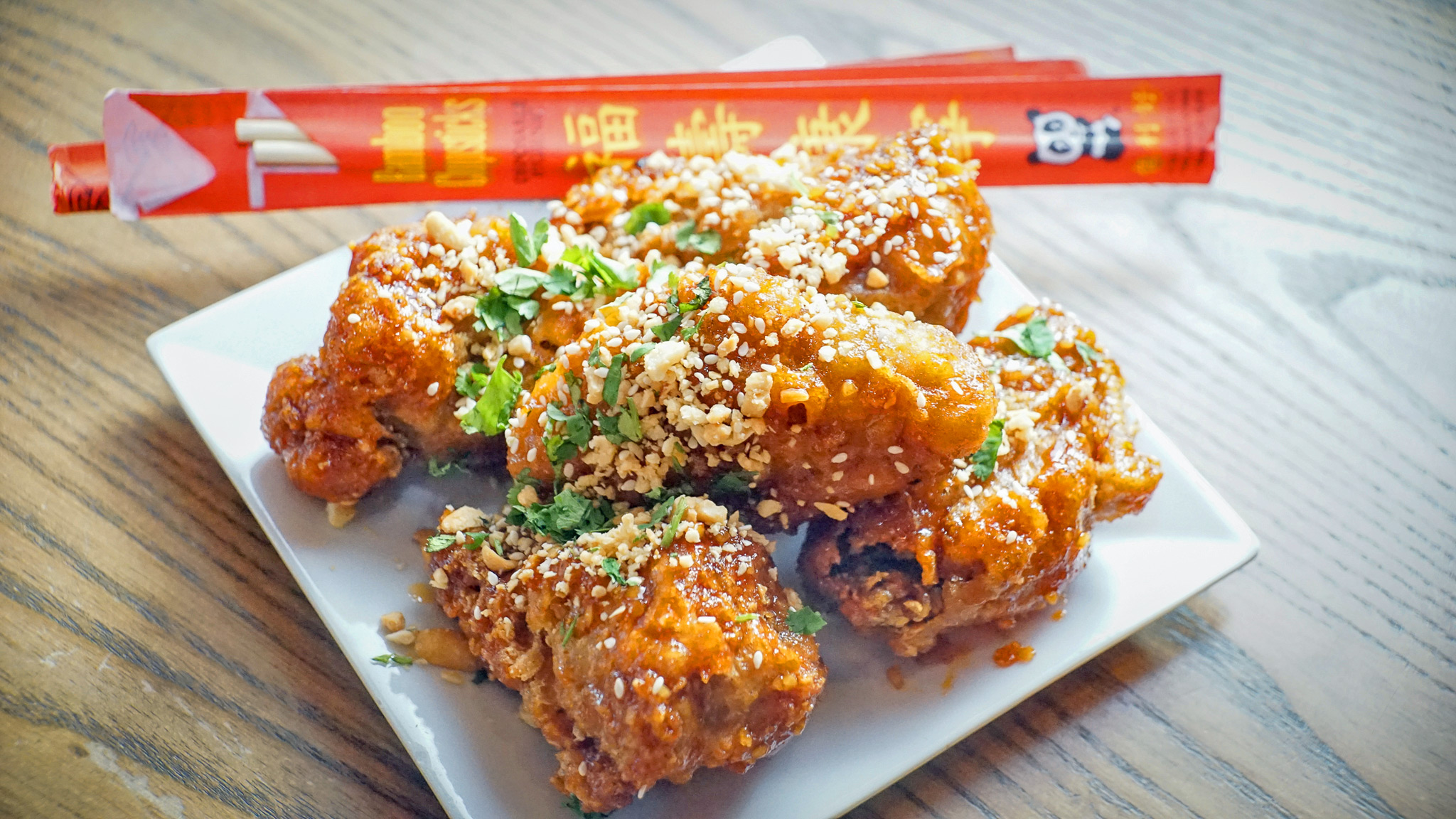 Korean Twice Fried Wings - garlic Gochujang sauce, peanuts, sesame, cilantro