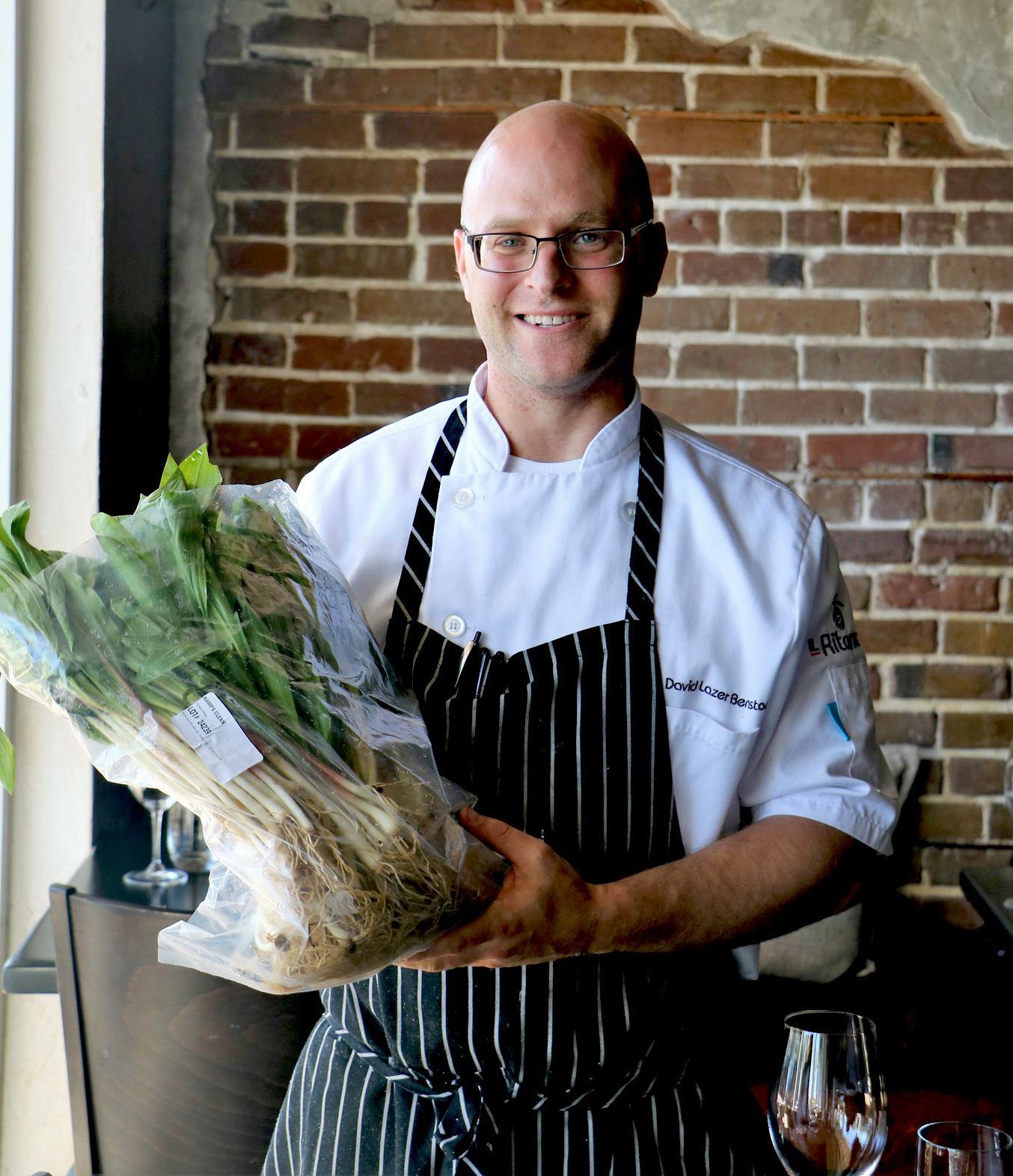 IL Ritorno - Chef David Benstock holding a bag of Ramps