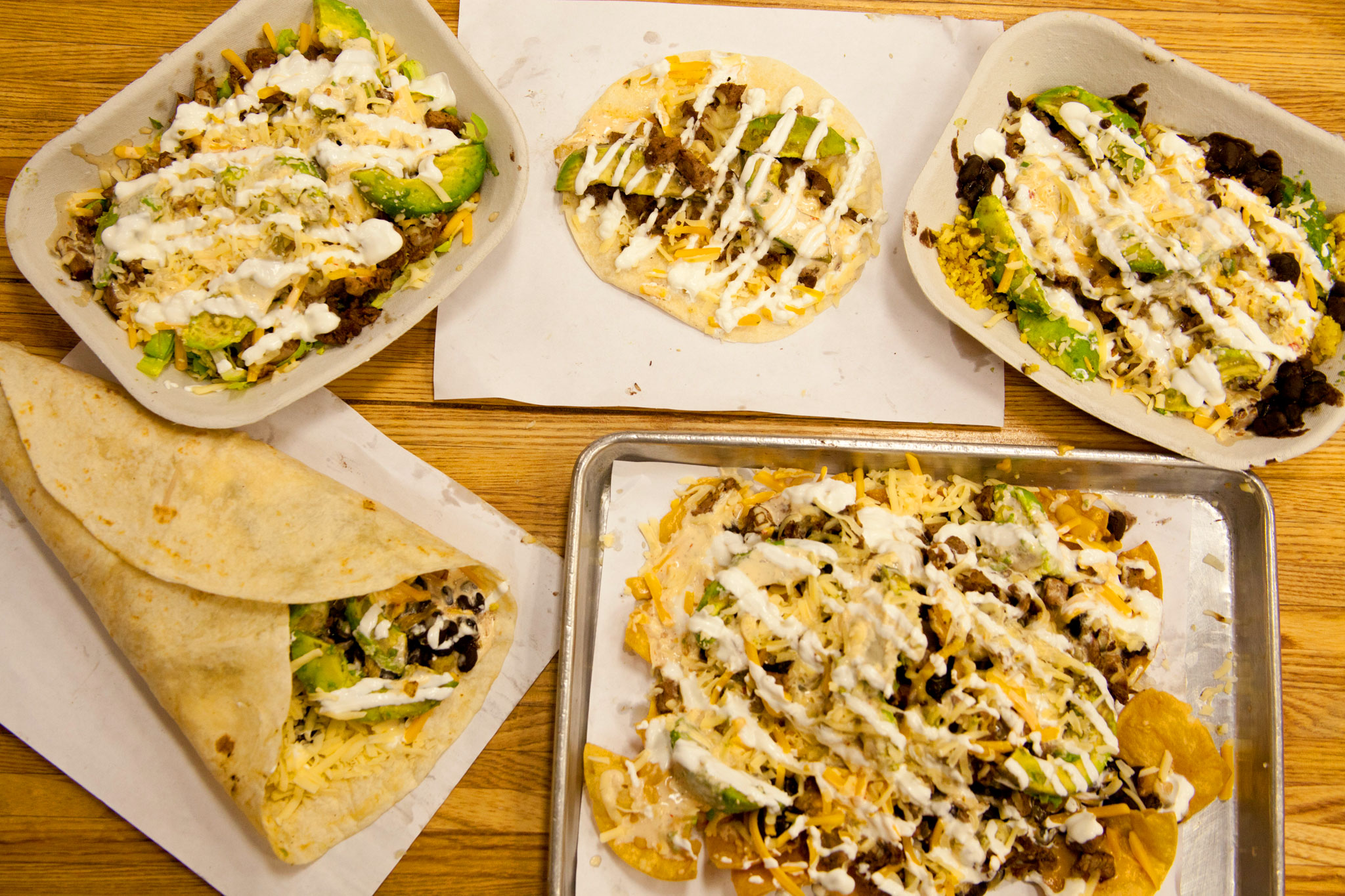 Austinite 5 Ways: The Austinite is the most popular menu item. This photo underscores the 5 ways you have any of our items - as a taco, burrito, rice bowl, salad or nachos. Carne Asada with jack & cheddar, caramelized onions, avocado, sour cream, chihuahua cheese, and chipotle ranch.