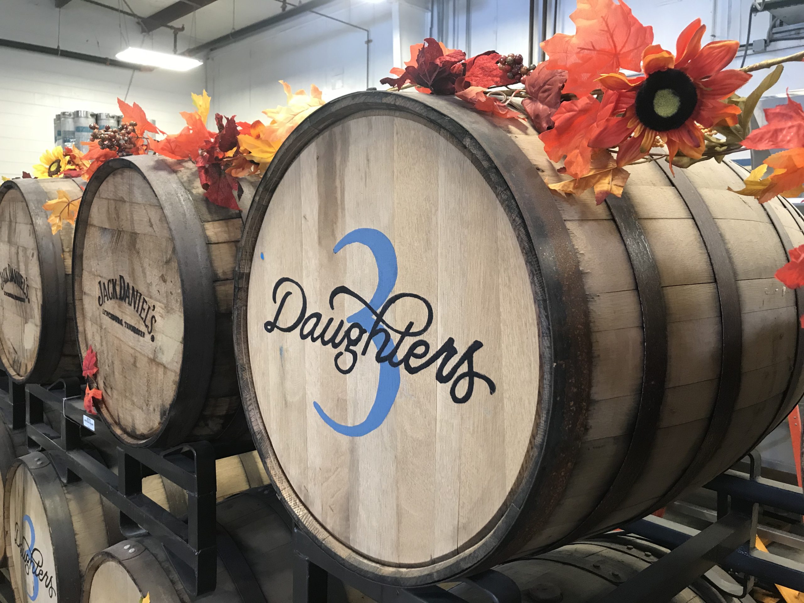 Barrels with the 3D logo in the brewery