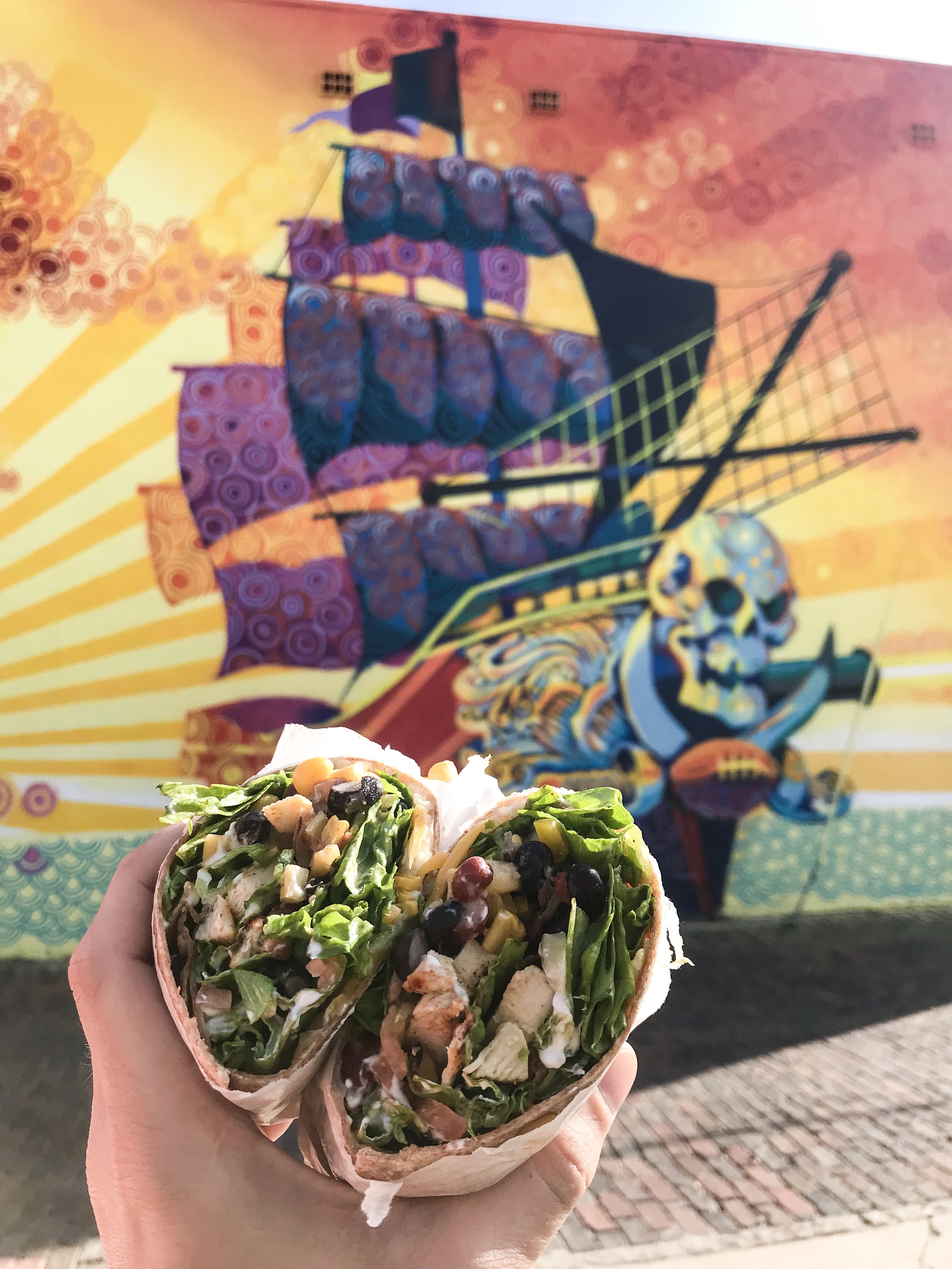 Southwest Wrap in front of a mural