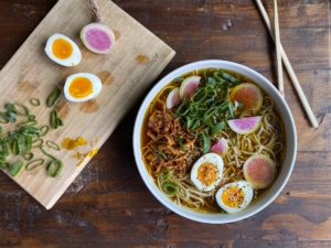 Ramen and sliced eggs and radishes