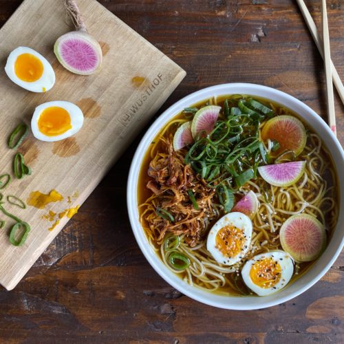Ramen and sliced eggs and radishes