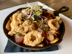 Seafood Nachos - yellowfin tuna, crispy calamari, lobster, crab queso, peppadews, tomatillo lychee salsa, avocado crema & potato crisps