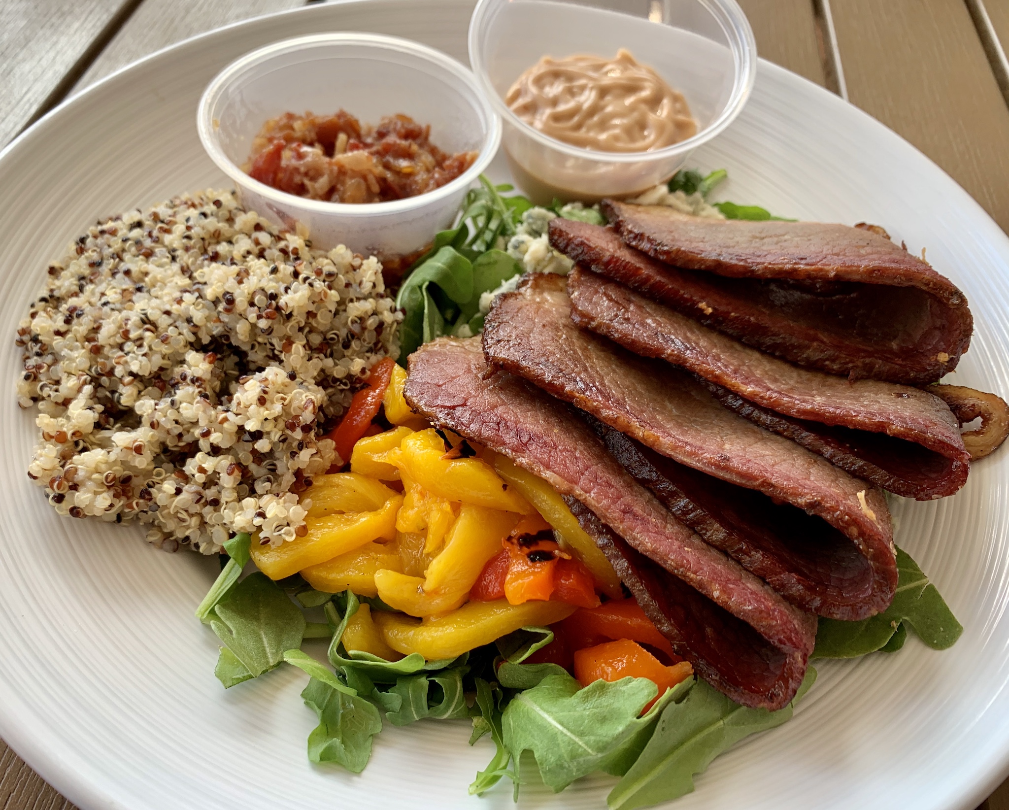 https://stpetersburgfoodies.com/wp-content/uploads/2020/08/Smoked-Brisket-Bowl-red-peppers-blue-cheese-bbq-mayo-red-onion-jalapeno-bacon-jam-and-arugula-with-quinoa.jpeg