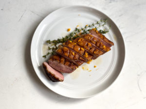 Sliced sous vide duck breast with orange sauce