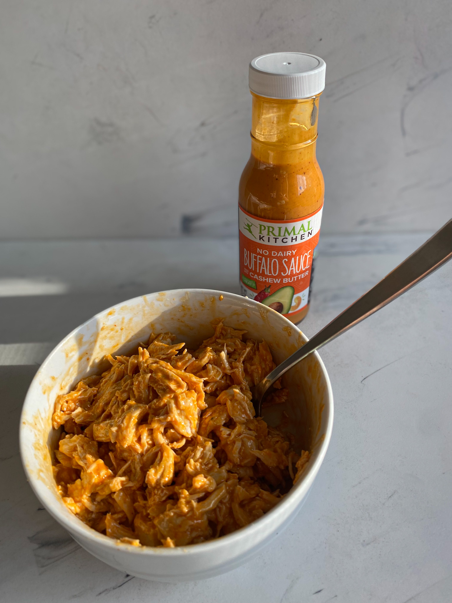 https://stpetersburgfoodies.com/wp-content/uploads/2021/09/Shredded-Chicken-Tossed-in-Primal-Kitchen-Buffalo-Sauce.jpg