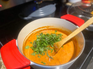 Curry sauce after a simmer with the addition of fresh herbs