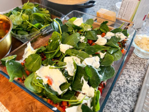 Dollops of mascarpone atop the spinach