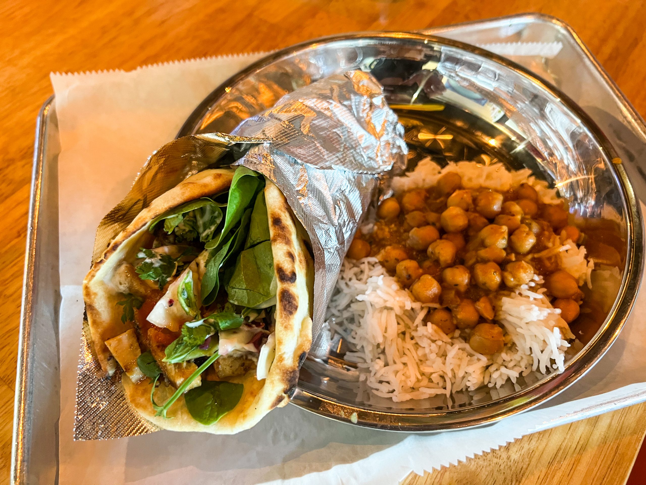 Chicken Tikka Masala Naanwich with a side of chickpeas and rice