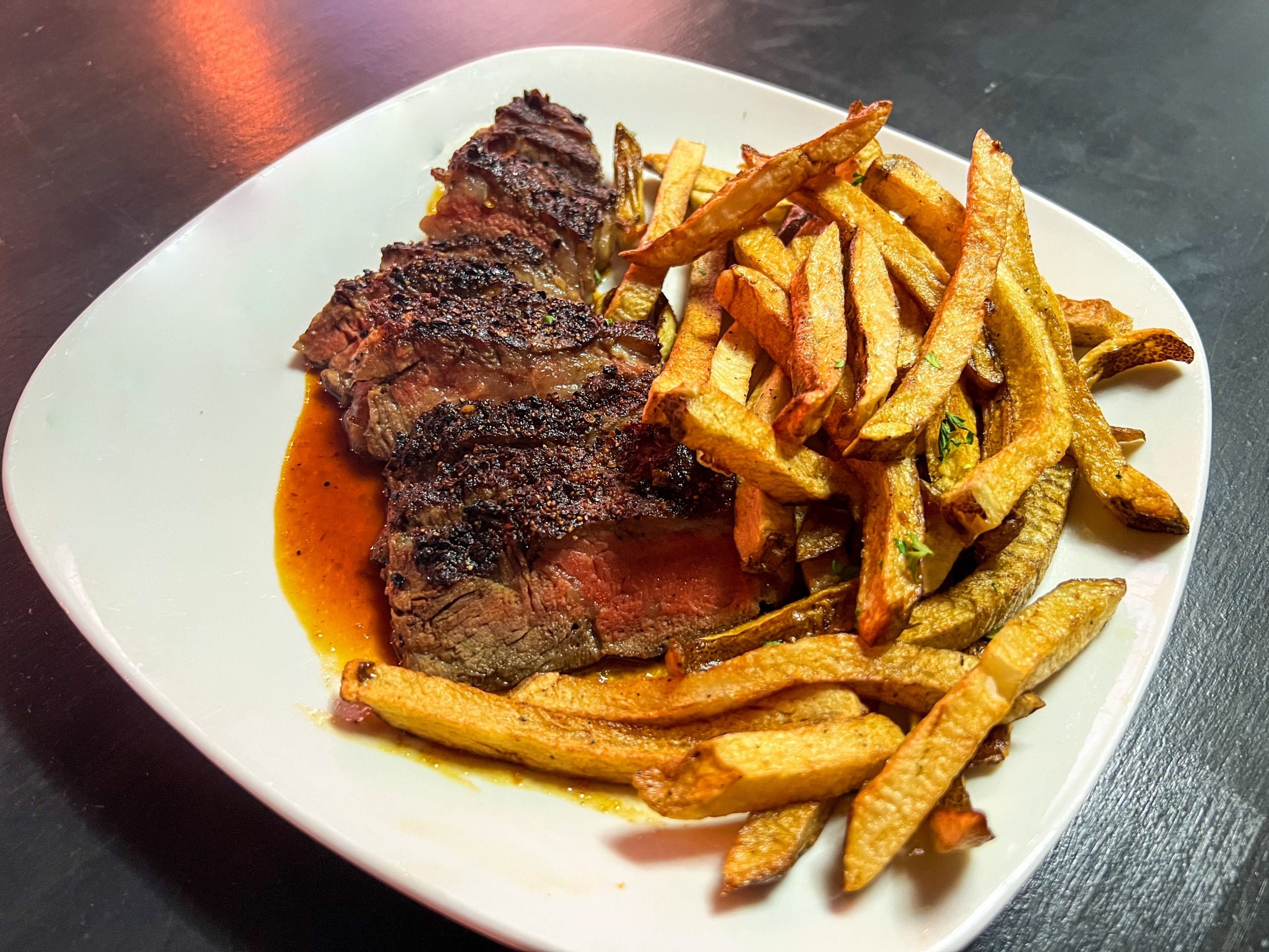 Petite Steak Frites which is a part of the happy hour menu