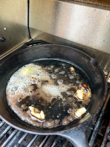 Smashed garlic in hot oil