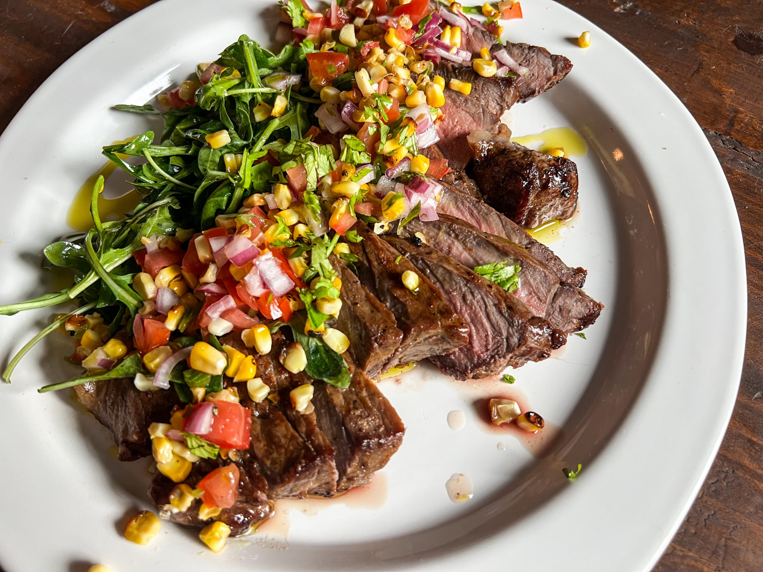 Tomato & Charred Corn Salsa over sliced steak