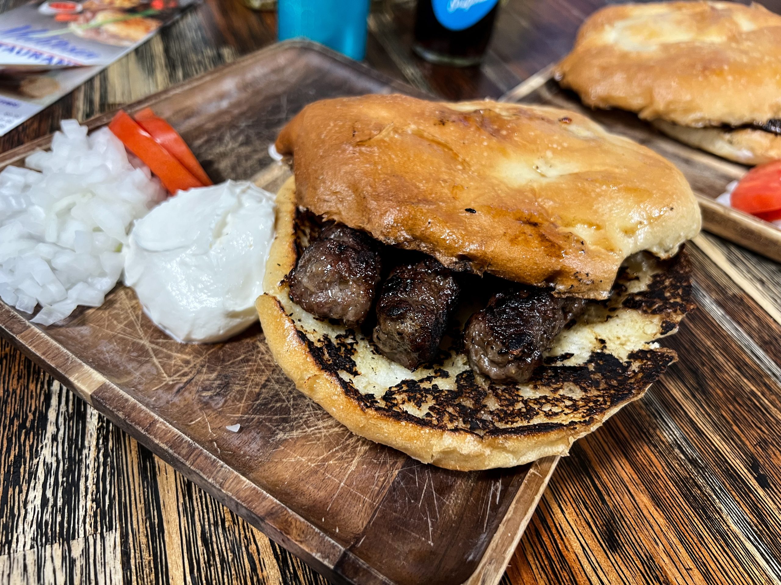 Up close and personal with a small order of the Cevapi - grilled dish of five minced beef links seved on traditional pita bread, generally found in the countries of Southeastern Europe