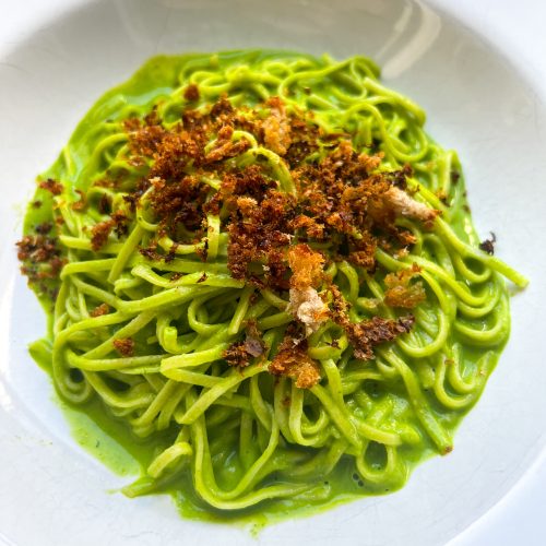 Plated pasta topped with the breadcrumbs