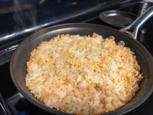 Rice evenly packed in the skillet