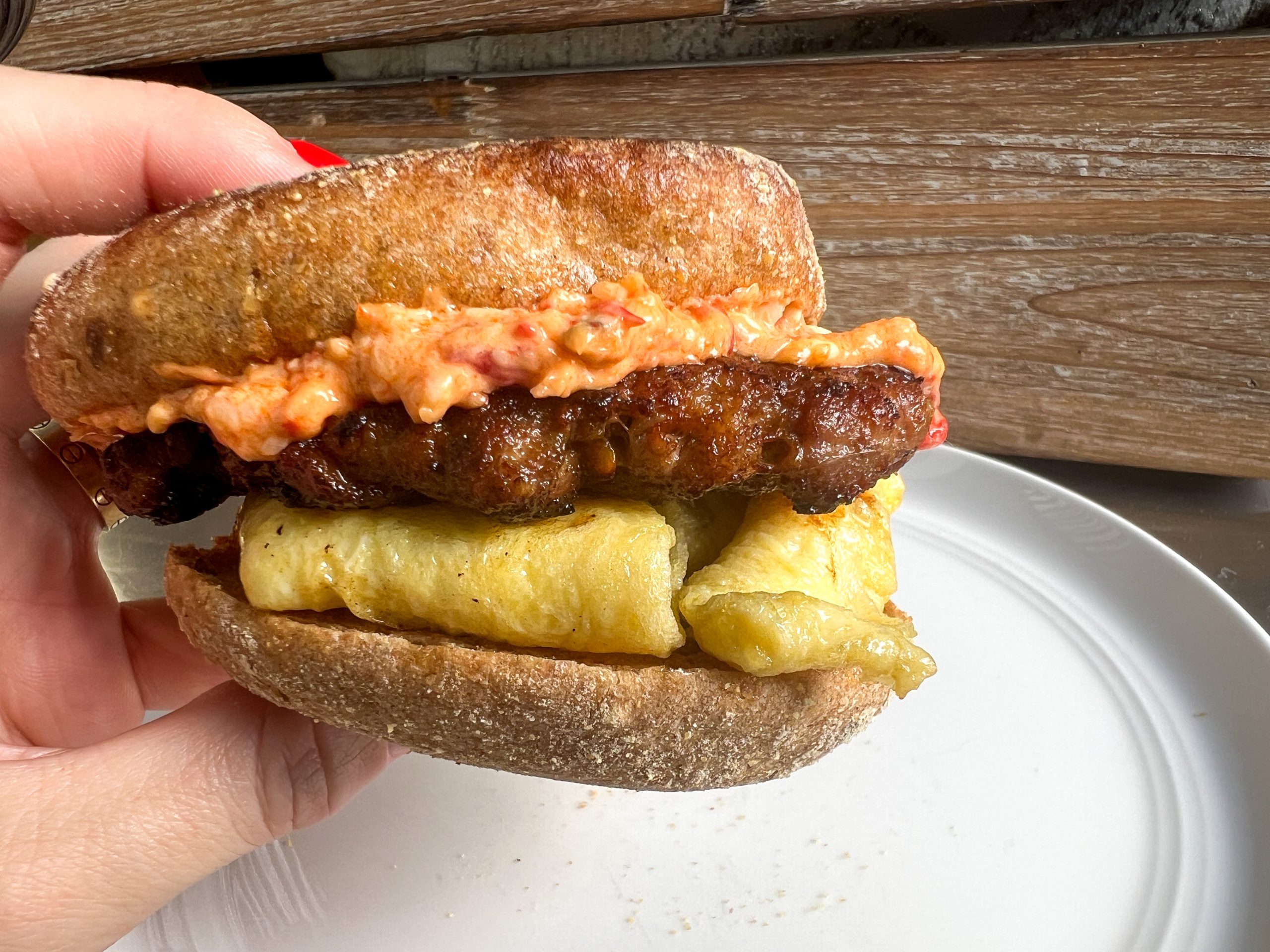 Sausage patty, egg and pimento cheese on an english muffin