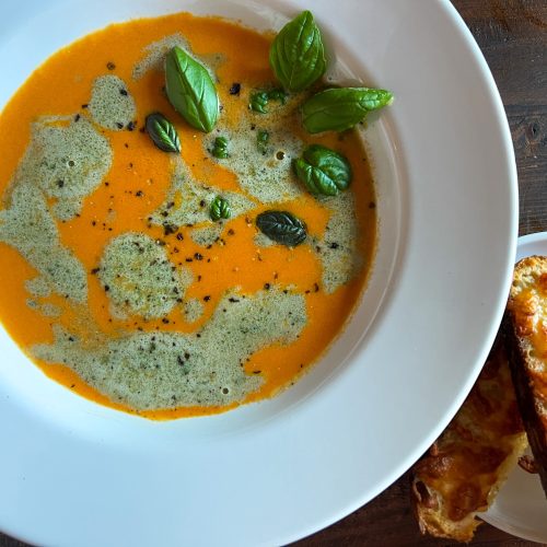 Spicy tomato soup with basil cream and toasted sourdough with cheese