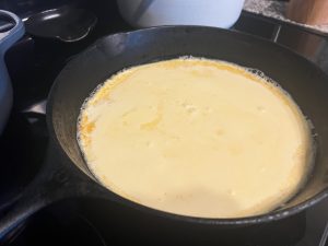 Batter poured into the hot buttered skillet