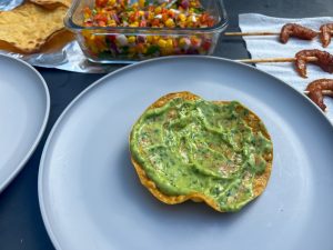 Avocado sauce is the first layer of the tostada