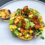 The spice on the shrimp pairs great with the other bright ingredients on this tostada