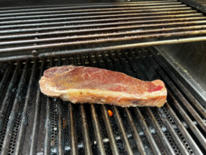 To grill the steak, lightly brush each side with olive oil and season liberally with salt