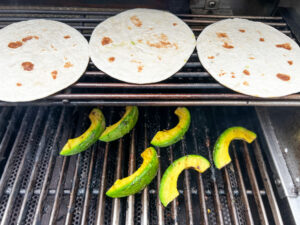 Grilling the avocado and warming the tortillas (optional)