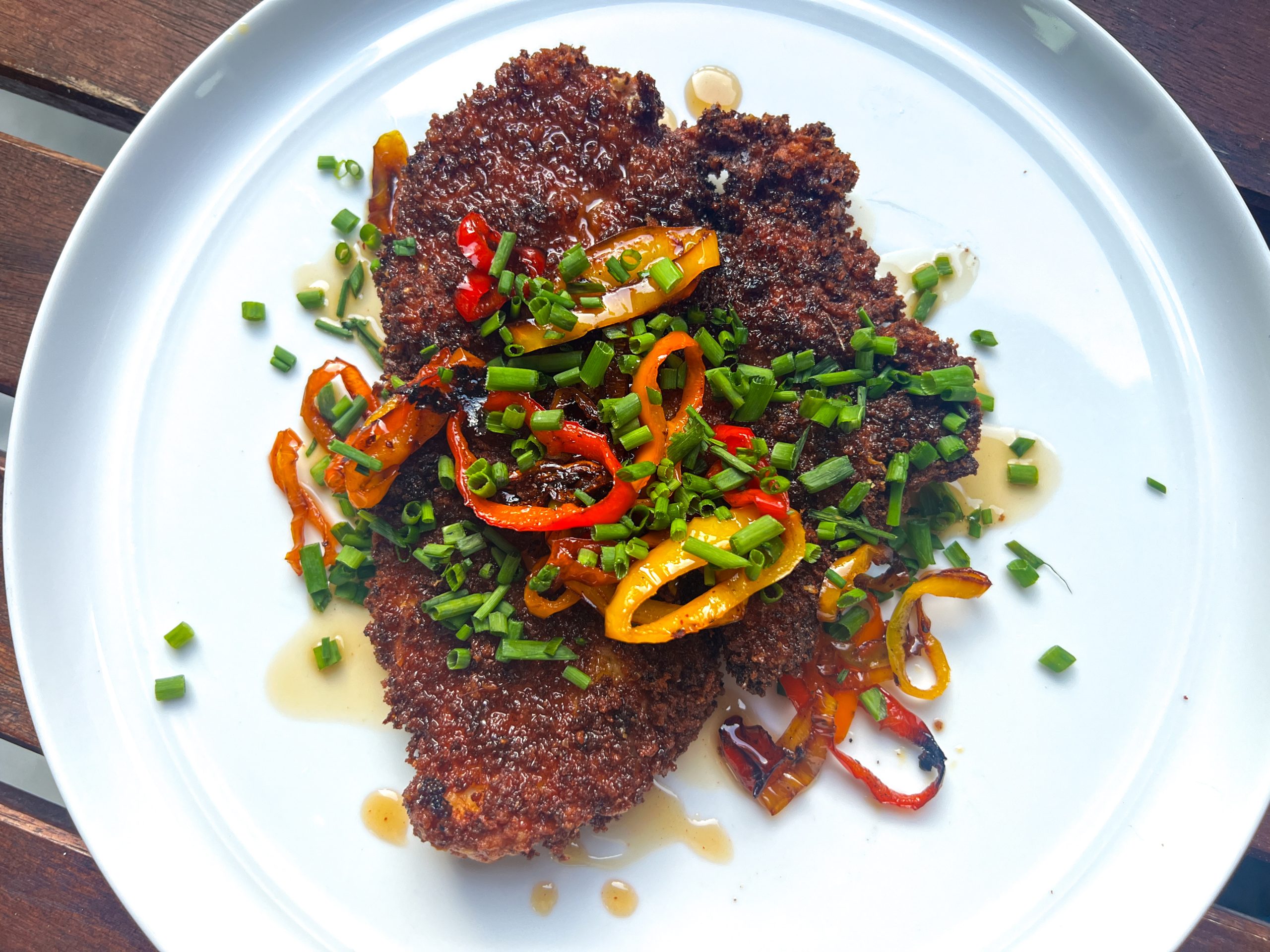 Crispy chicken cutlets with charred peppers, hot honey and lots of chives
