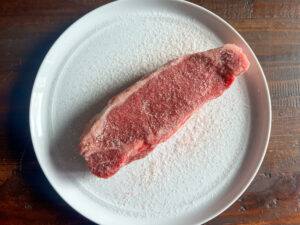 Salt the steak well a few hours or so before you plan to grill it and then refrigerate