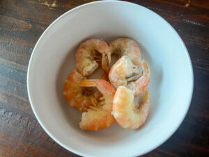 The shrimp after being poached and peeled