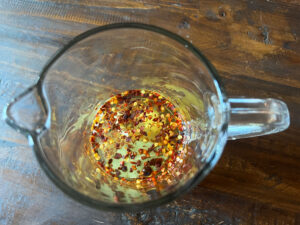 Vinegar, sugar, crushed red pepper, garlic and a bay leaf for the pickling liquid