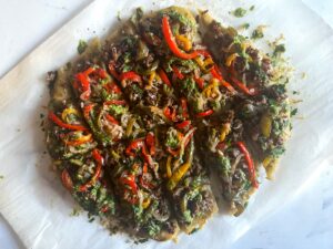 Flatbread topped with savory ground sausage, herbacious pesto and a tangy peperonata