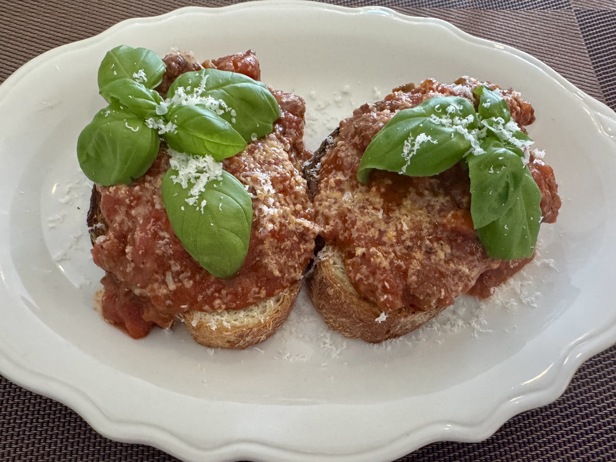 Grandpa Larry's Benedict - poached eggs, garlic bread, 24 hour meat rags, parmesan and basil