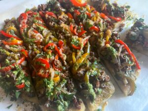 Sliced flatbread with chopped parsley and basil on top