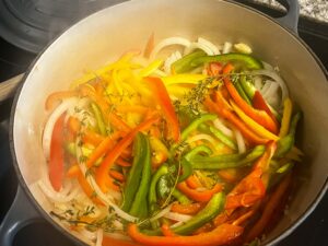 The peppers, onion and garlic softening